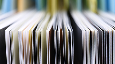 Rows of folders and manuals with pages sticking out