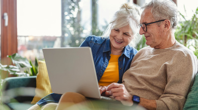 Older couple reviewing their retirement plan on computer.