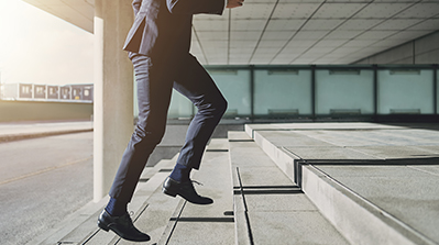 Person running up stairs outside building