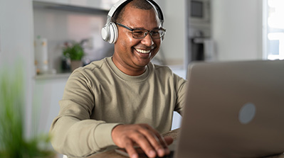 Man watching a video on a computer with a headset