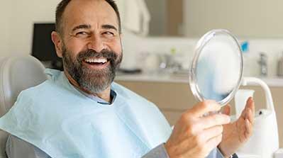 Patient looking at his dental work.