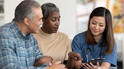 Couple reviewing Medicare Advantage Prescription Drug Plan with nurse.