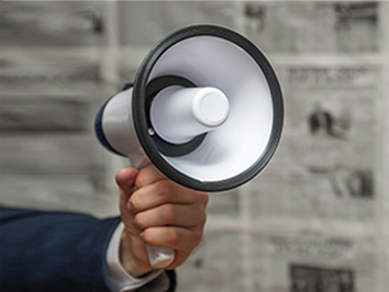 A hand holding a bullhorn.