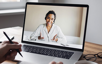 A laptop showing a webinar.