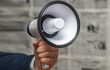 A hand holding a bullhorn.