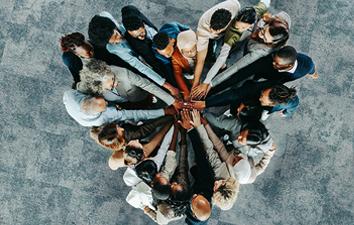 A group of people putting their hands in.