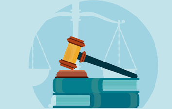 A gavel on books with a scale in the background.